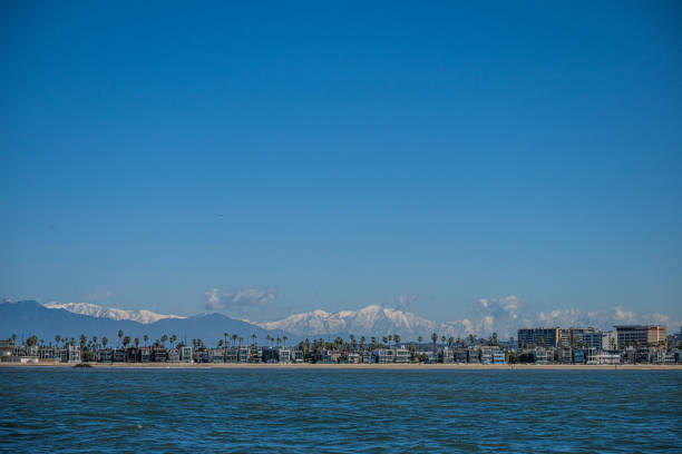 Snowcapped mountains over Los Angeles seen from pacific ocean.