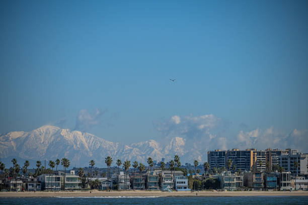 Snowcapped mountains over Los Angeles seen from pacific ocean.