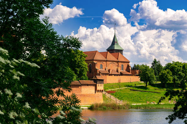 istock Ancient medieval village church reflected in the river water 2154781360