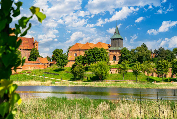 istock Ancient medieval village church reflected in the river water 2154781371