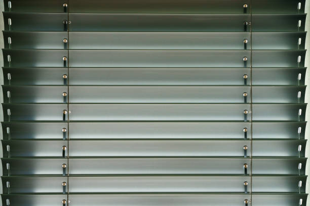 Workshop and office metal horizontal blinds line detail on background.