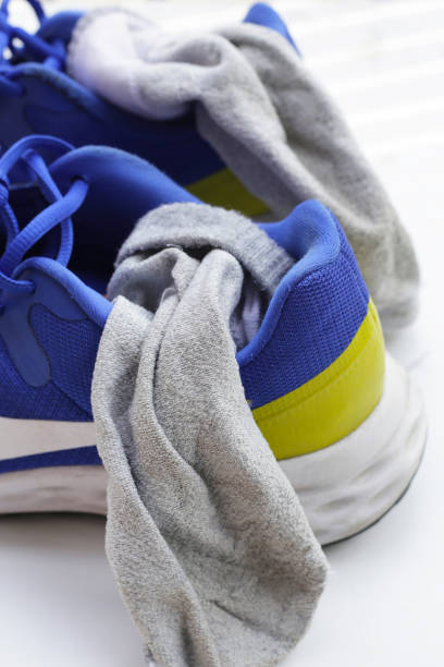 istock Blue sneakers with dirty socks 2154782352