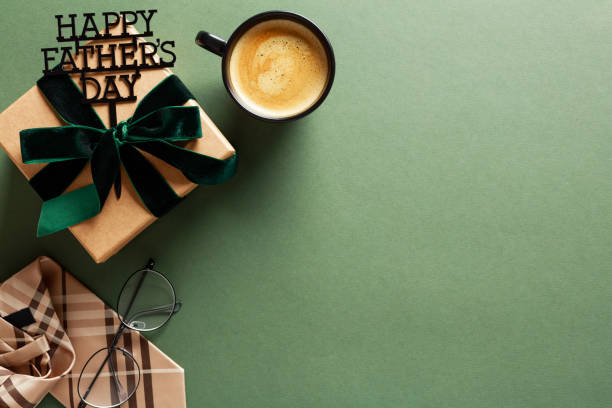 istock Happy Fathers Day concept. Flat lay composition with gift box, coffee cup, necktie, glasses on green background. 2154783687