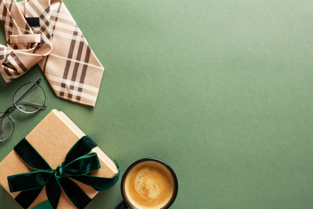 istock Happy Fathers Day greeting card template. Flat lay composition with gift box, coffee cup, tie, glasses on green background. 2154784002