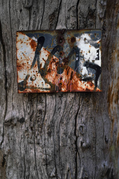 istock a rusty sign nailed to the trunk of a tree 2154784429