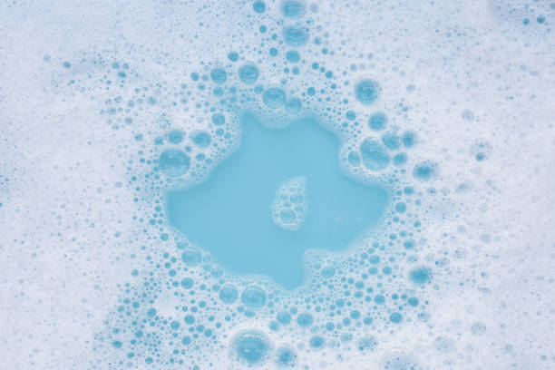 istock Detergent foam bubble on water. Blue background, Soap sud 2154784696
