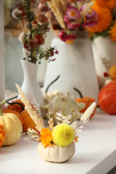 istock Small pumpkin with autumn bouquet on window sill indoors, selective focus 2154786241