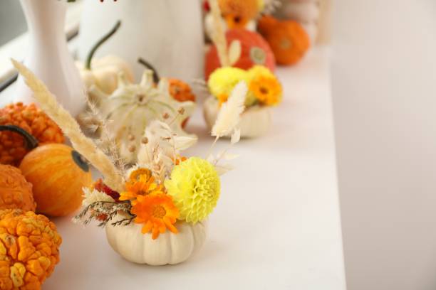 istock Small pumpkin with autumn bouquet on white window sill indoors, selective focus. Space for text 2154786249