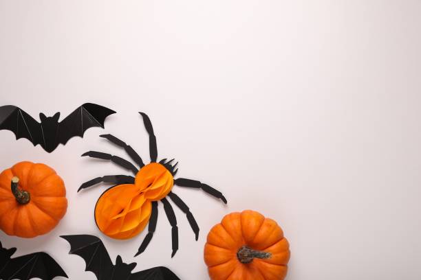istock Cardboard bats, pumpkins and spider on white background, flat lay with space for text. Halloween celebration 2154786284