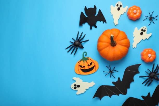 istock Flat lay composition with bats, pumpkins, ghosts and spiders on light blue background, space for text. Halloween celebration 2154786288