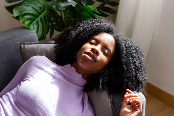 istock Relaxed woman enjoying sunshine indoors 2154788569