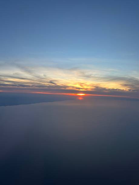 istock Sunset from plane window over the ocean 2154788742
