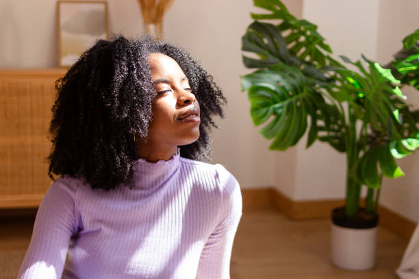 istock Serene woman enjoying sunlight indoors 2154789356