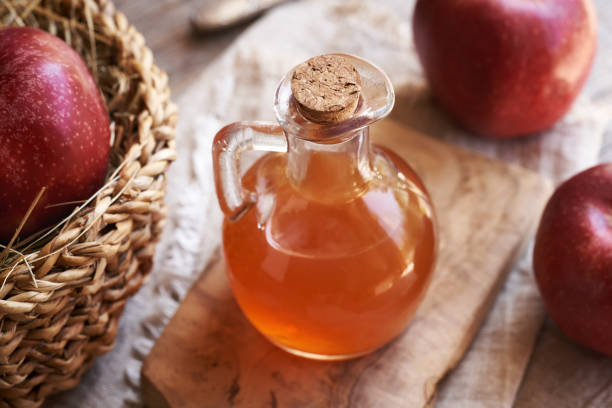 istock A bottle of apple cider vinegar with fresh apples on a table 2154789746