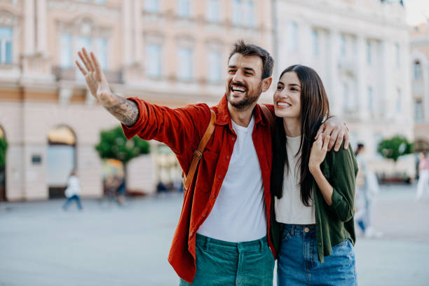 istock Couple pointing and looking at city sights 2154789769