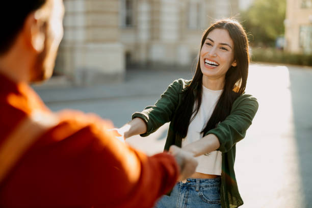 istock Playful couple playing in a sunny city setting 2154789795