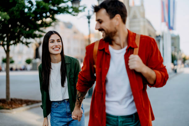 istock Joyous couple walking and laughing together 2154789877