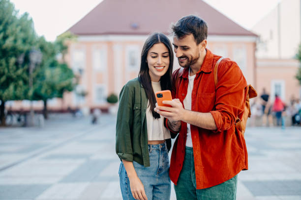 istock Couple with smartphone on city street 2154789921