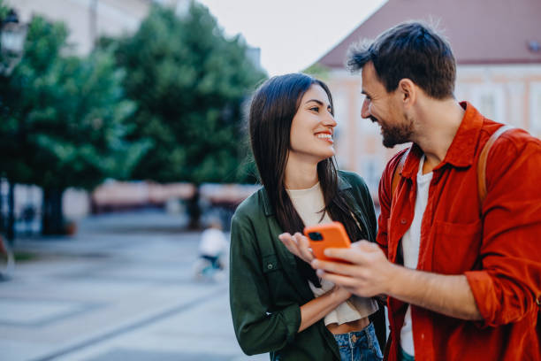 Couple engrossed in smartphone outdoors