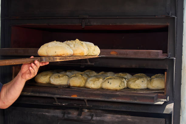 istock Fresh artisanal bread in industrial oven 2154791068