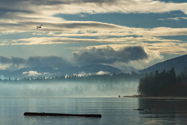 A small single engine plane comes in for a landing along the river in Comox, British Columbia.