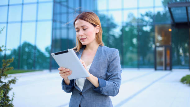 istock Young businesswoman enjoying outdoors and using tablet 2154791517