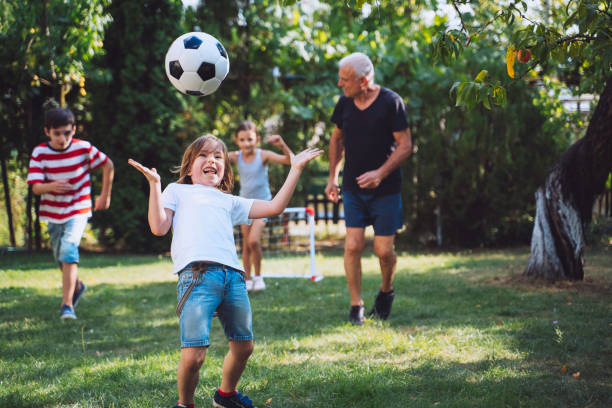 istock Boy tossing soccer ball playfully 2154792531