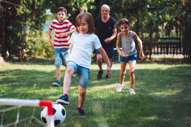 istock Boy kicking soccer ball in goal 2154792534