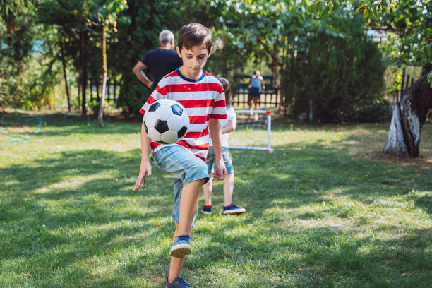 istock Young boy juggling soccer ball 2154792538