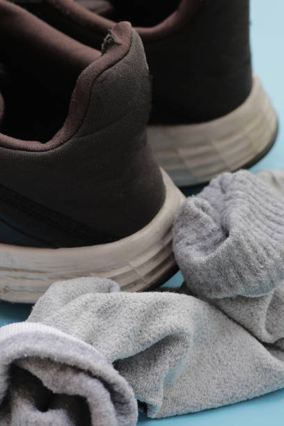 istock Black sneakers with dirty socks 2154793230