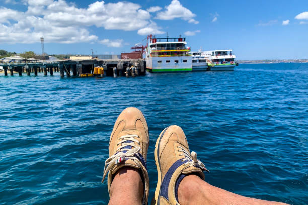 Natural man legs with blue sea background.