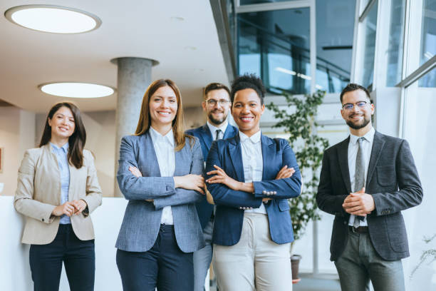istock Smiling business team standing in office 2154795268