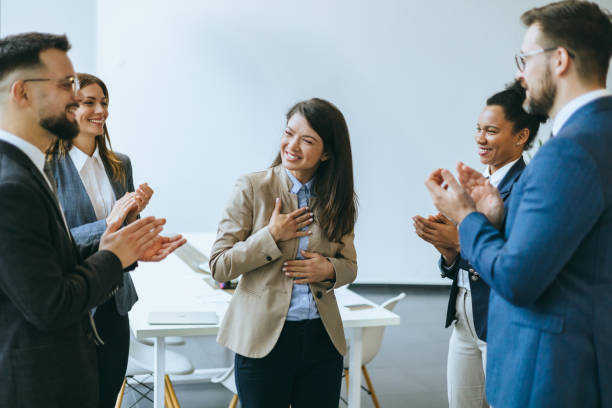 istock Professional team members cheering a colleague 2154795272