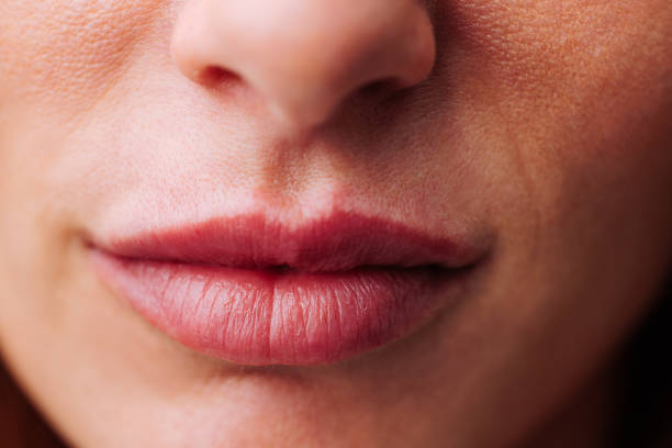 istock Close-up of woman's lips in soft light 2154796380