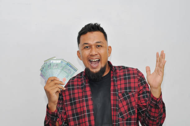 istock a man happy waving Cash. White background. Expression of face 2154801739