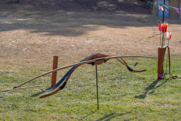 Medieval archery equipment, wooden bow and arrow. Medieval fair. High quality photo