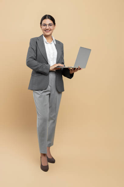 istock Smiling woman in formal wear using laptop for office work 2154801997