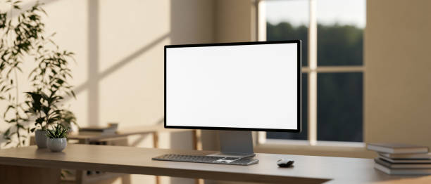 istock A computer with a white-screen mockup on a wooden table in a modern, minimalist home office. 2154805909