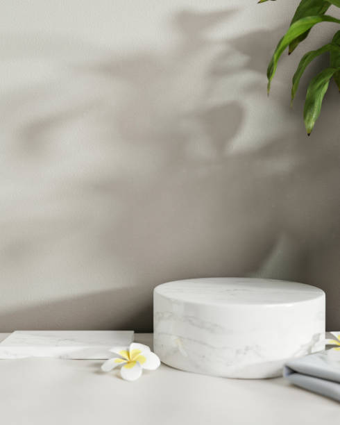 istock Circle and rectangle white marble podiums are on a white table against the white wall. 2154805927
