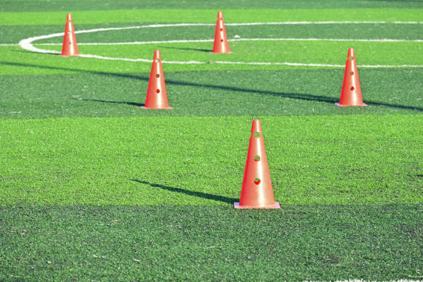 istock artificial green grass soccer field with orange training cones 2154806135