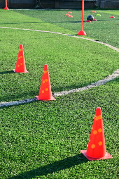 istock artificial green grass soccer field with orange training cones 2154806136