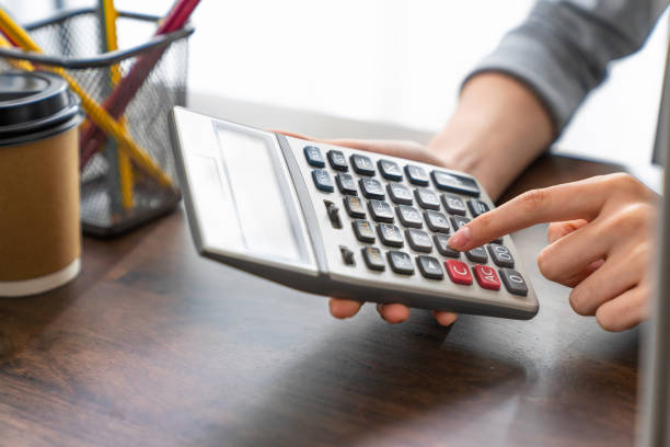 istock Hand holding calculator and calculate various expenses. 2154806335