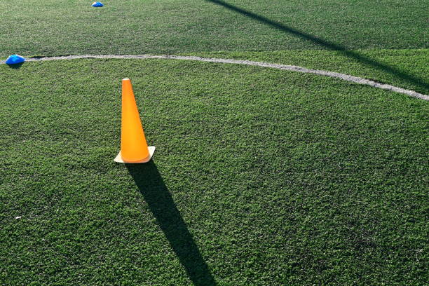 istock artificial green grass soccer field with orange training cones 2154806443