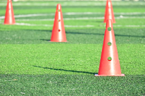 istock artificial green grass soccer field with orange training cones 2154806786