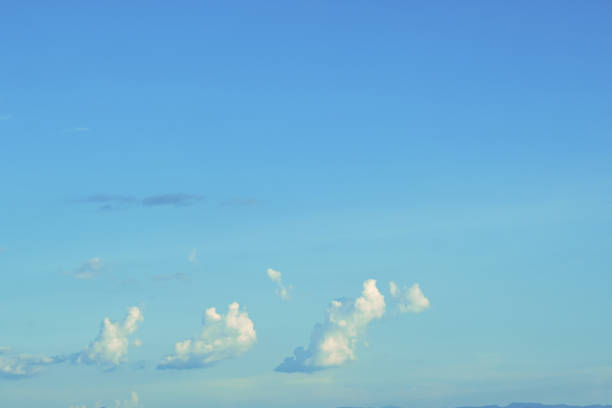 Blue sky with beautiful white clouds. Sky with cumulus and cirrocumulus clouds. Panoramic image of the sky.