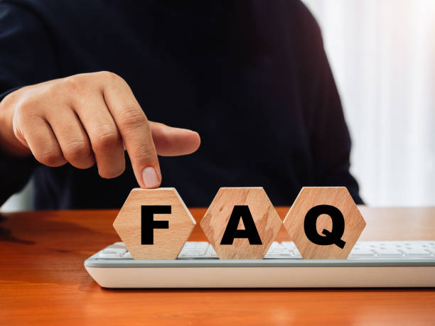 istock Frequently asked questions concept, questions and answers intended to help people understand particular subject. Word FAQ on wood hexagon blocks pointing by website admin hand, on keyboard computer. 2154807239