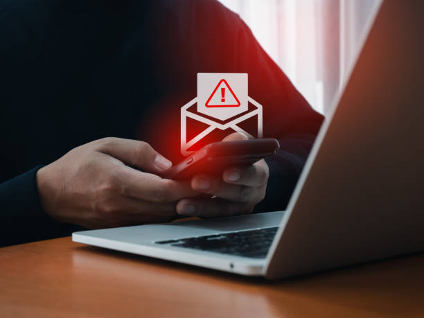 istock SMS spam and fake text message phishing from scammer concept. SMS hacked warning alert, email hack, scam malware spreading virus on message alert virtual on mobile phone screen in man's hands. 2154807294