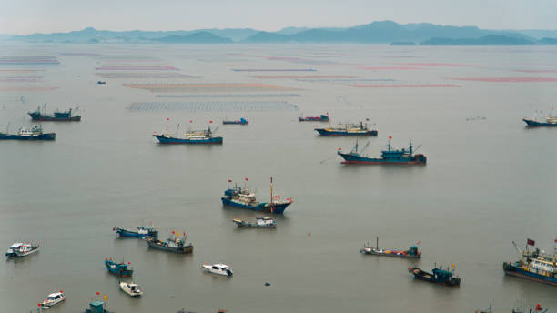 istock Fishing boat dredging at the seaside 2154807369