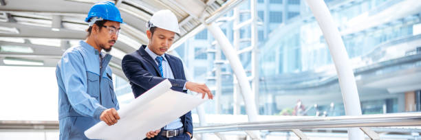 istock Banner Two engineer man look at blueprint architecture building contractor designer. Engineer holding project planing partner teamwork. Two Man meeting together construction site with copy space 2154808546
