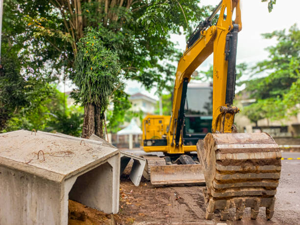 istock Excavator with reinforced concrete box culverts. On the site of a sewage system replacement. 2154808572